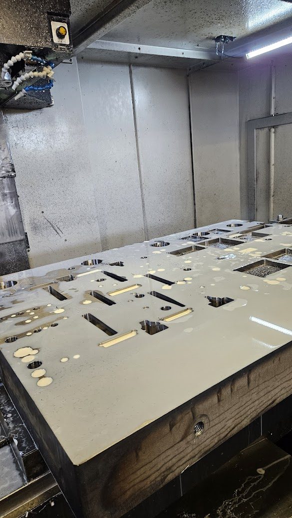 Steel plate being machined on a CNC milling machine
