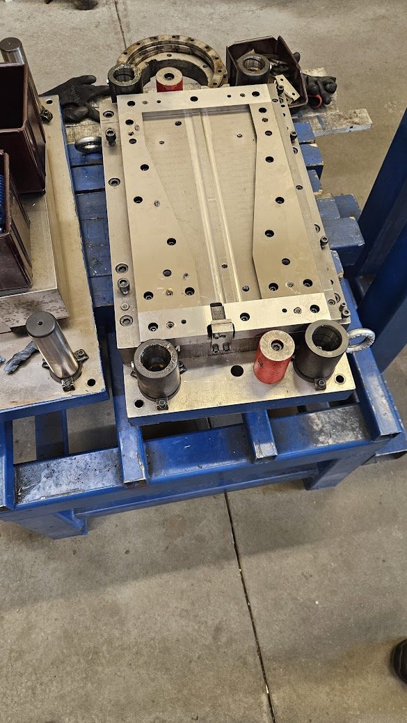 Machined die base plate on assembly stand